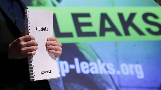 Gassner of Greenpeace holds a copy of the leaked TTIP negotiations in Berlin 
