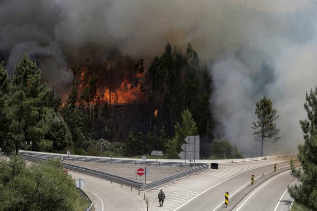 Fire and smoke is seen on the IC8 motorway during a forest fire near Pedrogao Grande
