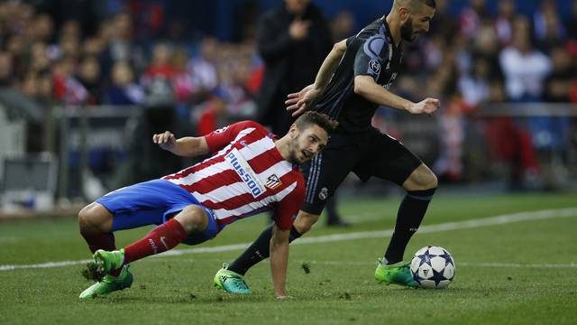 Real Madrid's Karim Benzema in action with Atletico Madrid's Koke