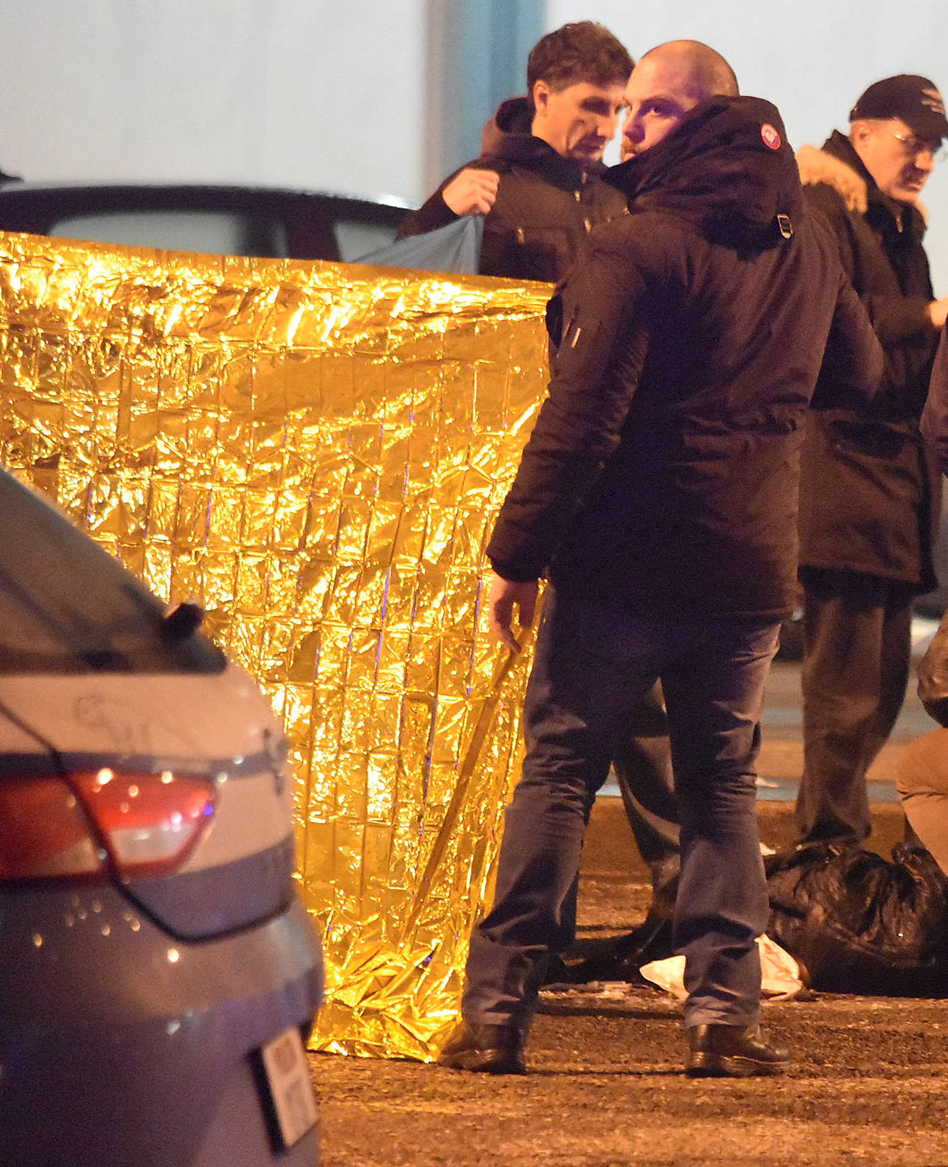 Italian Police officers work next to the body of Anis Amri, the suspect in the Berlin Christmas market truck attack, in a suburb of the northern Italian city of Milan