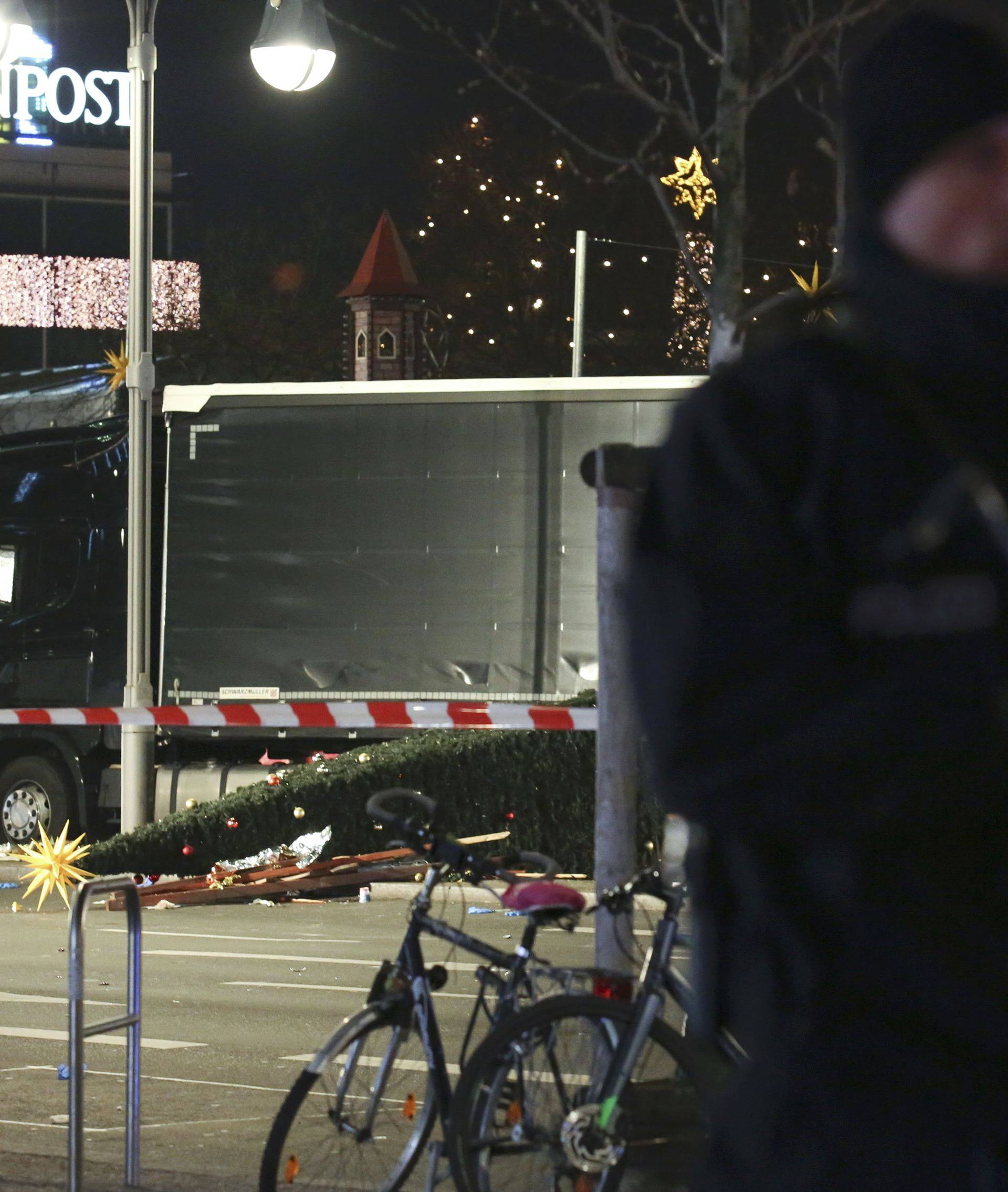 A German police officer guards a truck at a Berlin Christmas market following an accident