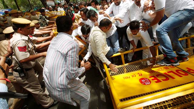 Supporters of India's main opposition Congress party break police barricades during what the party calls as a "Save Democracy" march to parliament in New Delhi