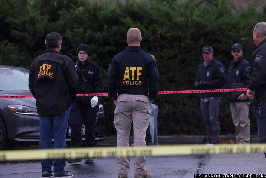 Law enforcement officers collect evidence near the scene of a shooting at the Boise Towne Square shopping mall in Boise, Idaho