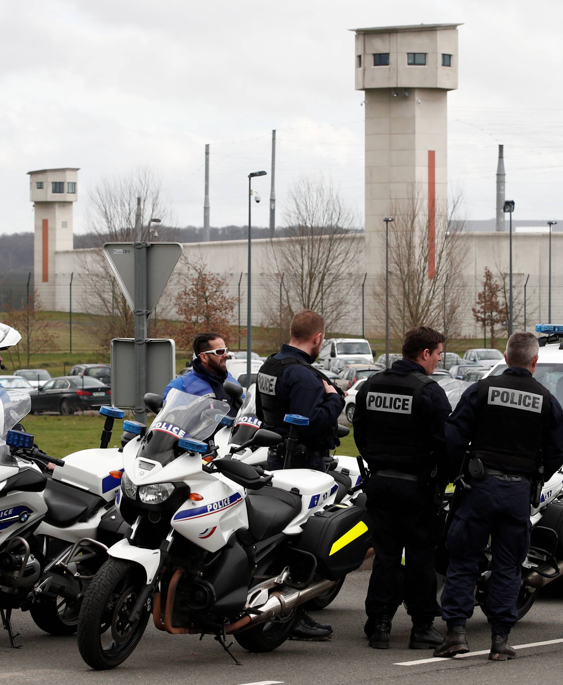 French police take position outside the prison where an inmate in one of France's most secure prisons stabbed two guards with a knife in Conde-sur-Sarthe