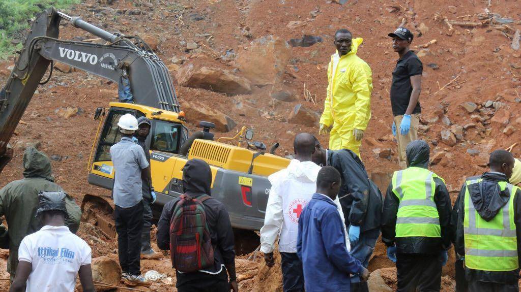 Rescue workers search for survivors after a mudslide in the Mountain town of Regent, Sierra Leone