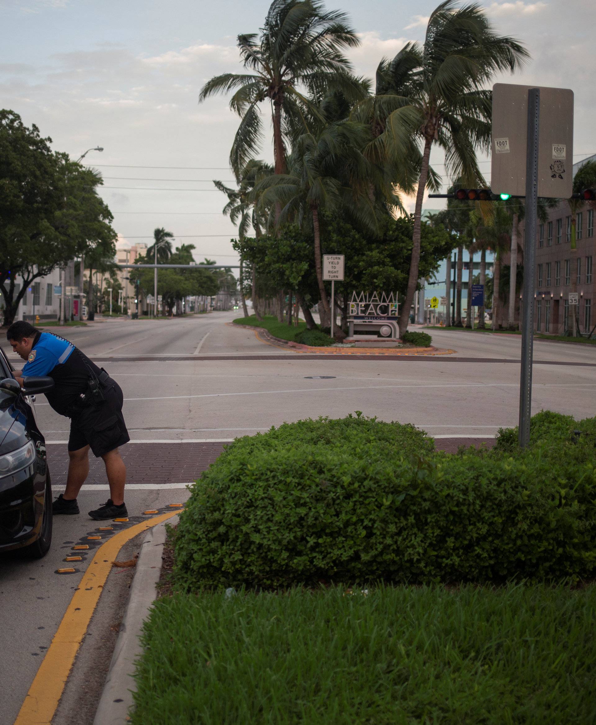 Miami Beach Police Department officers speak at an intersection ahead of the arrival of Hurricane Irma in Miami Beach, Florida