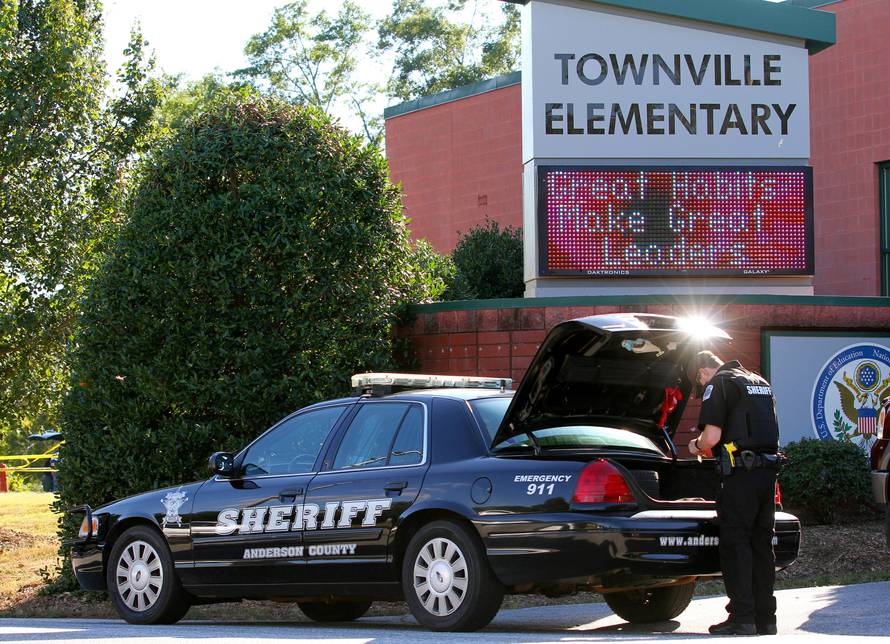An Anderson County sheriff's deputy stands outside of Townville Elementary School after a shooting in Townville