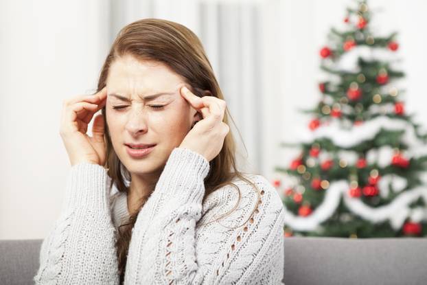 young girl has headache of christmas stress