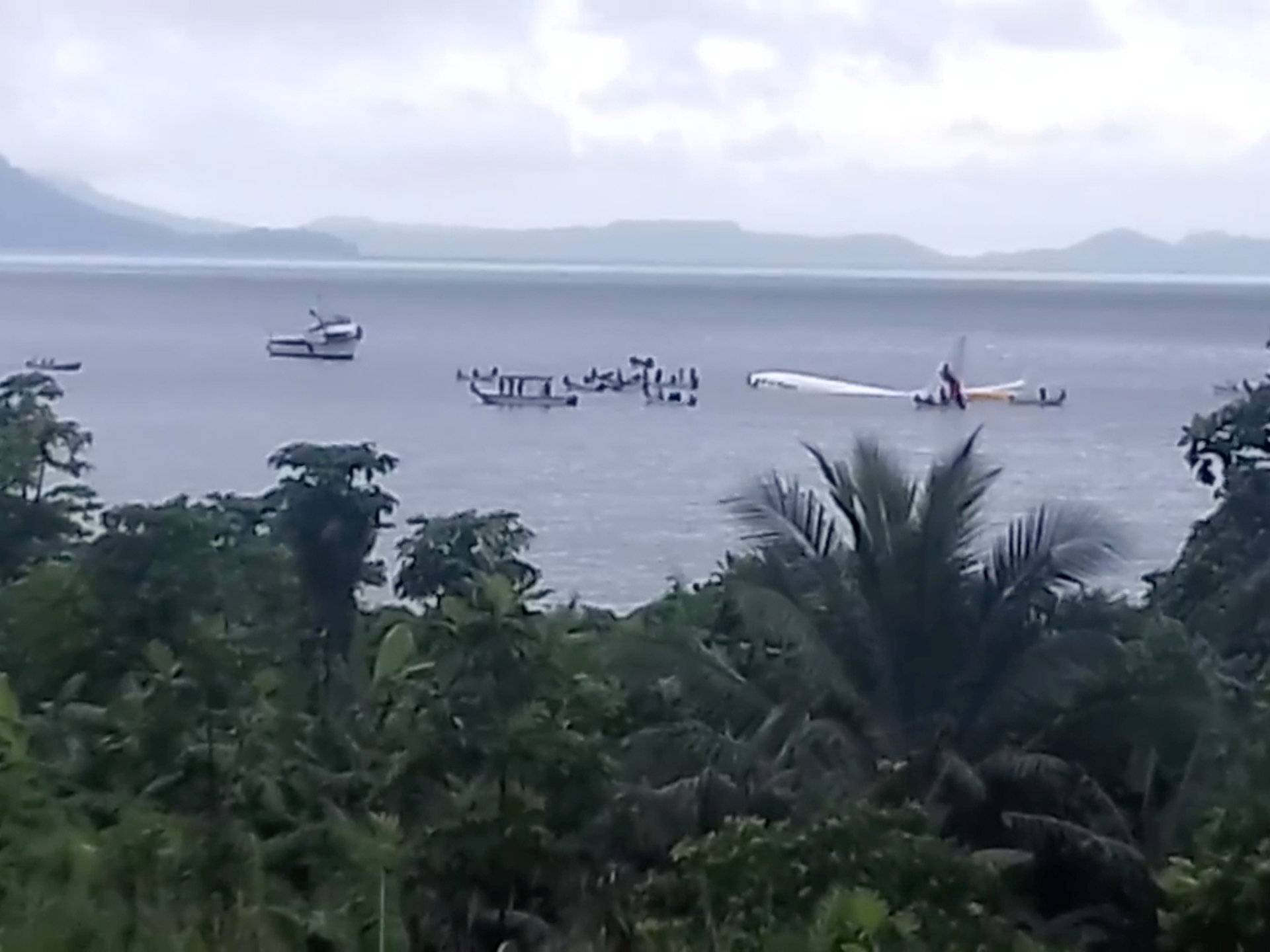 People are evacuated from an Air Niugini plane which crashed in the waters in Weno, Chuuk, Micronesia