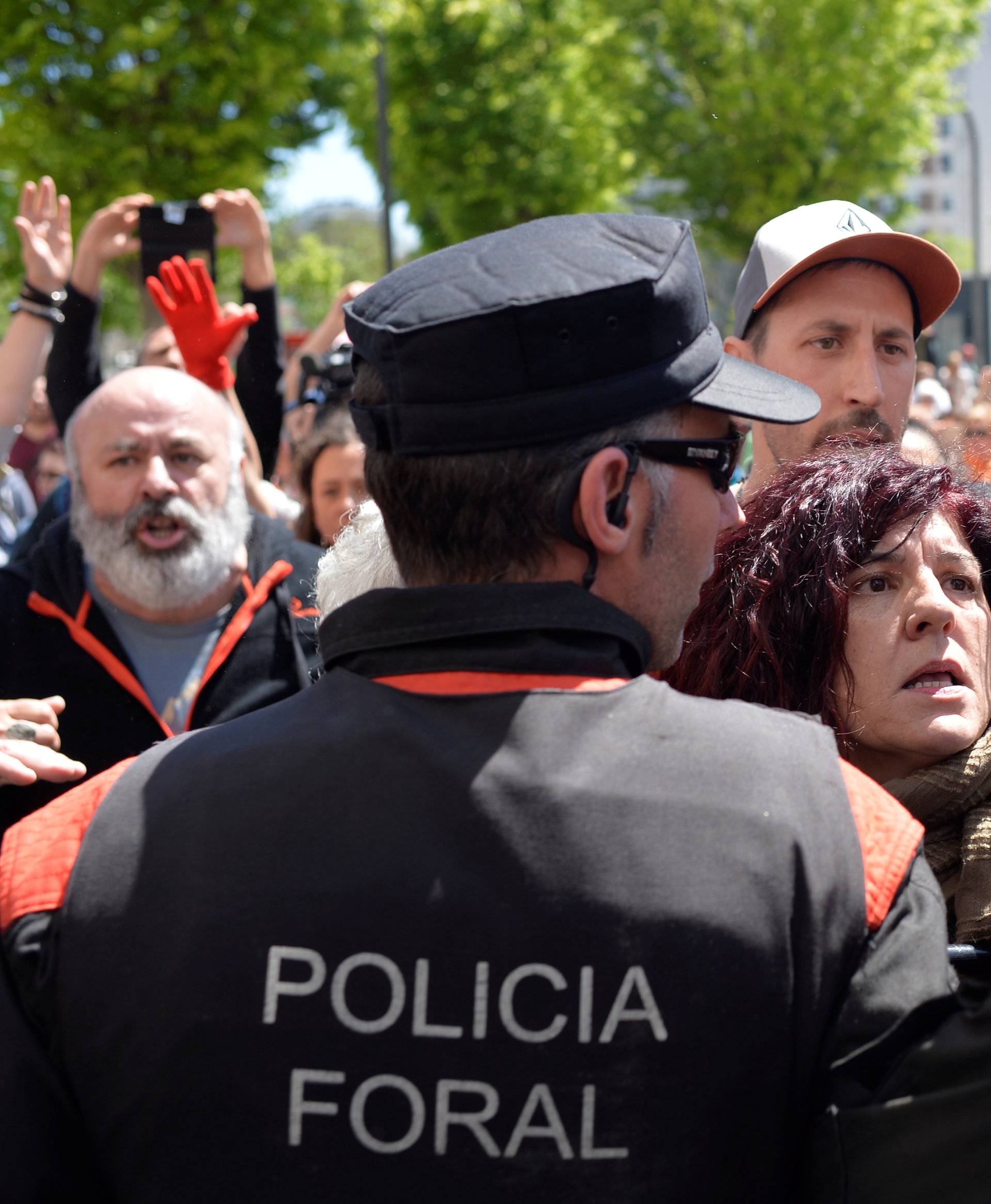 Protesters break through a police line after a nine-year sentence was given to five men accused of the multiple rape of a woman during Pamplona's San Fermin festival in 2016