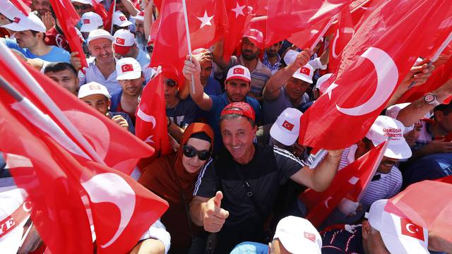 People hold Turkey's national flags during the Democracy and Martyrs Rally in Istanbul