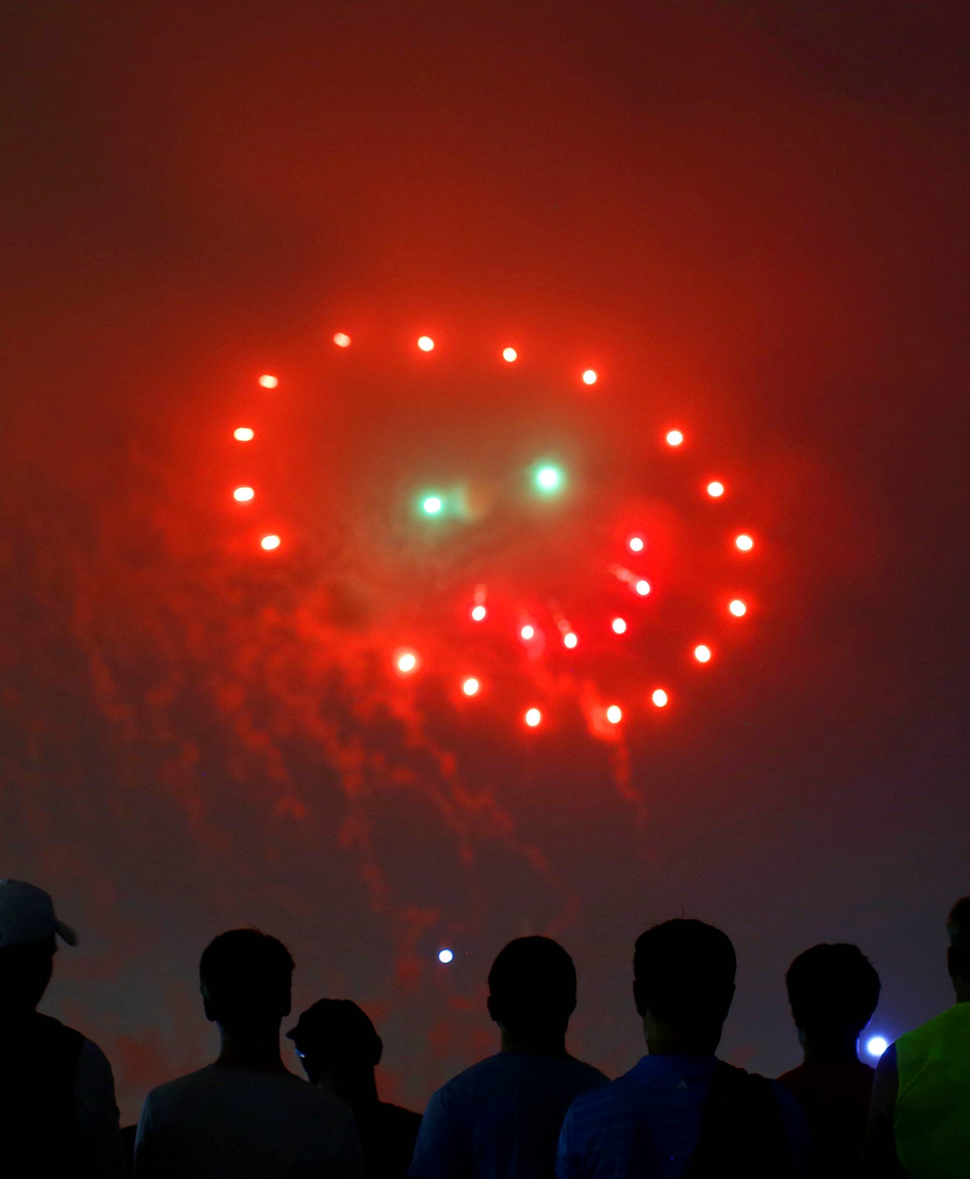 People watch fireworks in the form of a 'smiley face' during the 4th of July Independence Day celebrations at the National Mall in Washington, U.S.