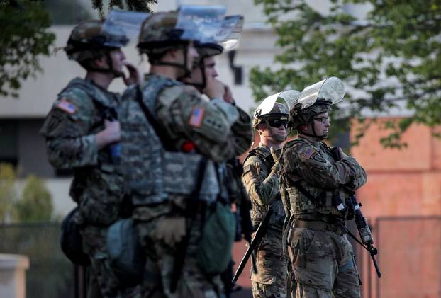 Members of the Wisconsin National Guard stand by as people gather for a vigil, following the police shooting of Jacob Blake, a Black man, in Kenosha, Wisconsin