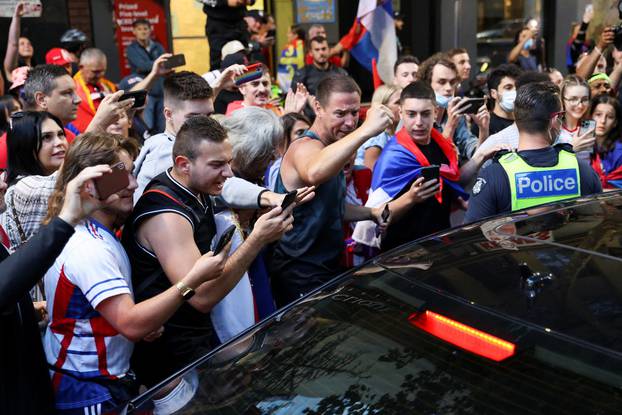 Supporters of Serbian tennis player Novak Djokovic rally in the street, in Melbourne