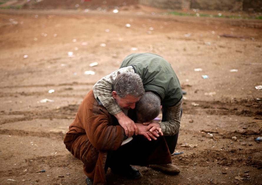 An Iraqi father mourns the death of his son, who was killed during clashes in the Islamic State stronghold of Mosul, in al-Samah neighborhood, Iraq