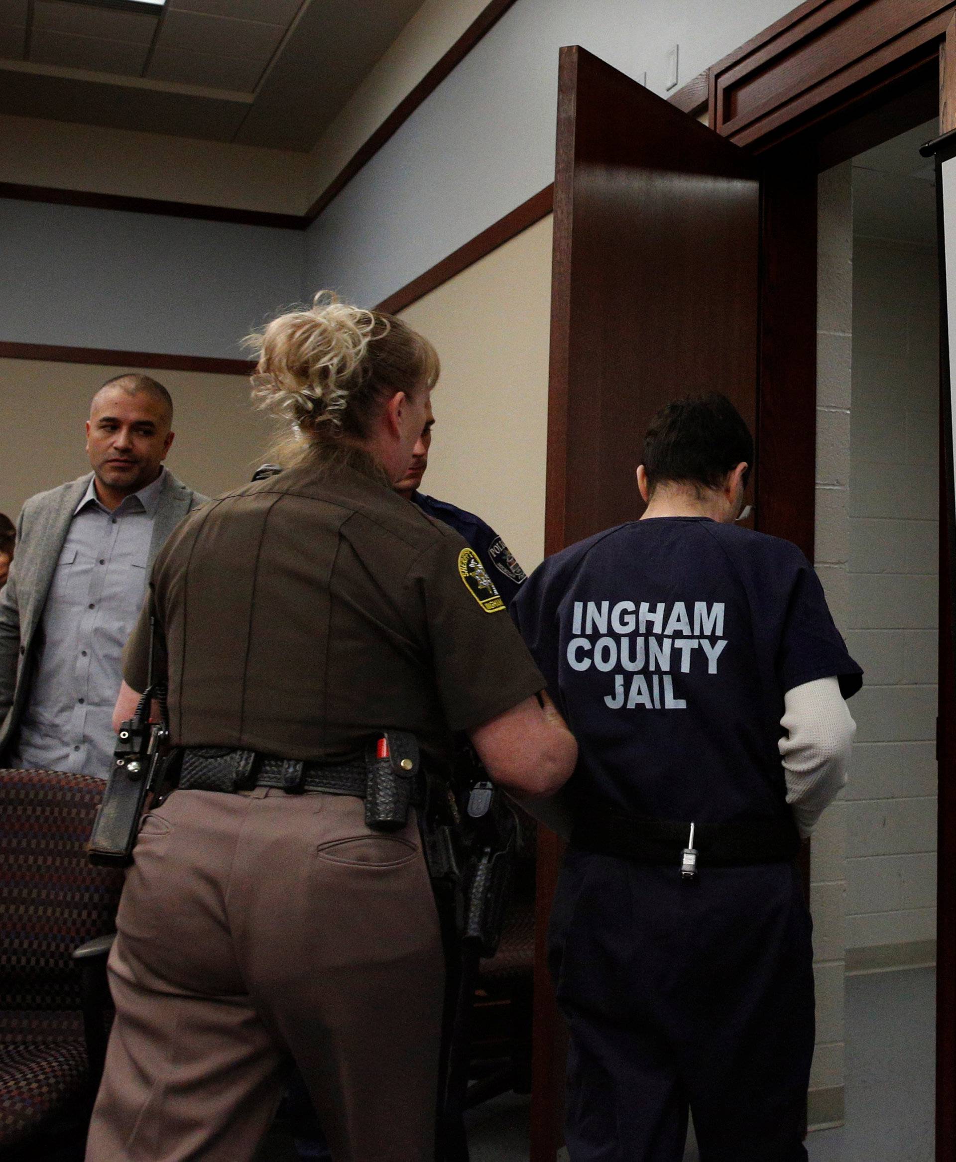 Larry Nassar, a former team USA Gymnastics doctor, who pleaded guilty in November 2017 to sexual assault charges, is led from the courtroom after listening to victim testimony during his sentencing hearing in Lansing, Michigan