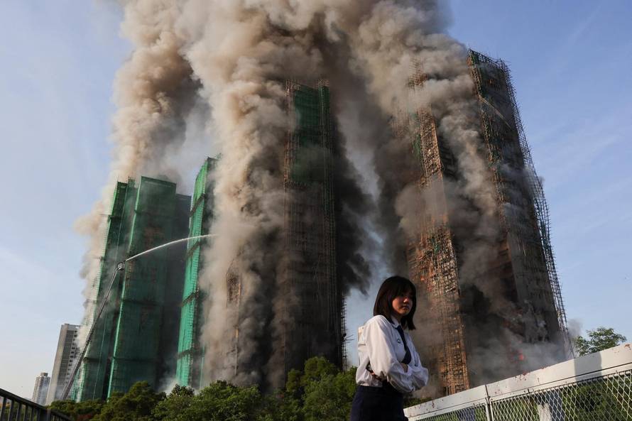 Flames engulf bamboo scaffolding across multiple buildings at Wang Fuk Court housing estate, in Tai Po