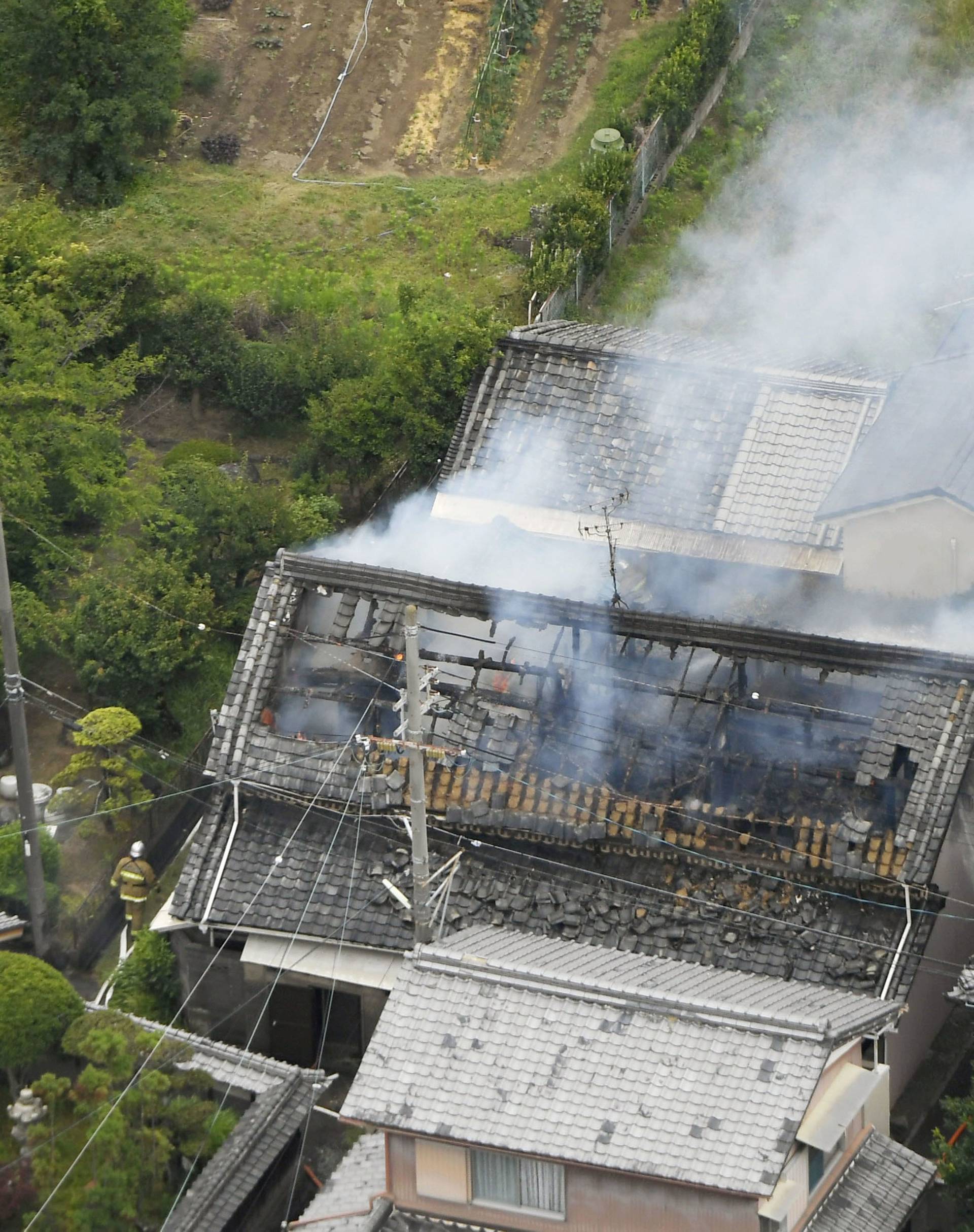 Smoke arise from a house where a fire breaks out, in Takatsuki