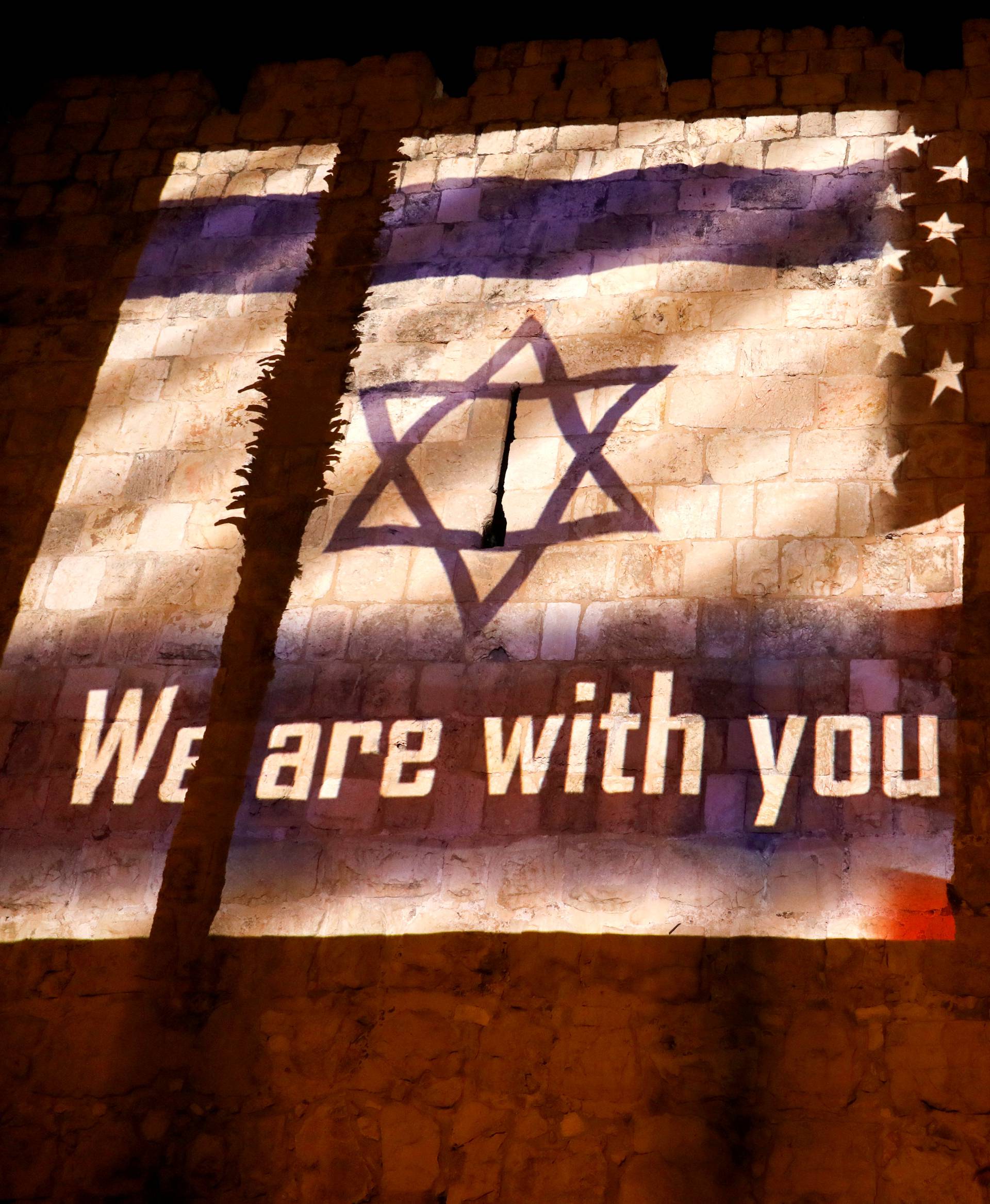 An image of Israeli and American flags with the wording, "We are with you - Pittsburgh" is projected on the walls of Jerusalem's Old City, in solidarity with the victims of a synagogue shooting in Pittsburgh