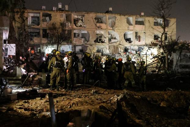 Israeli soldiers work at the scene of damage after Iranian missile barrages struck Dimona, amid the U.S.-Israel conflict with Iran, in southern Israel