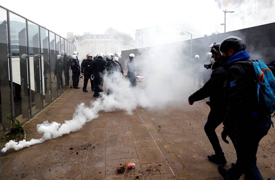 Police officers use tear gas during a protest against Marrakesh Migration Pact in Brussels