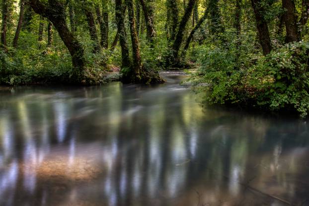 Turquoise color of water in the summer on the river Janj