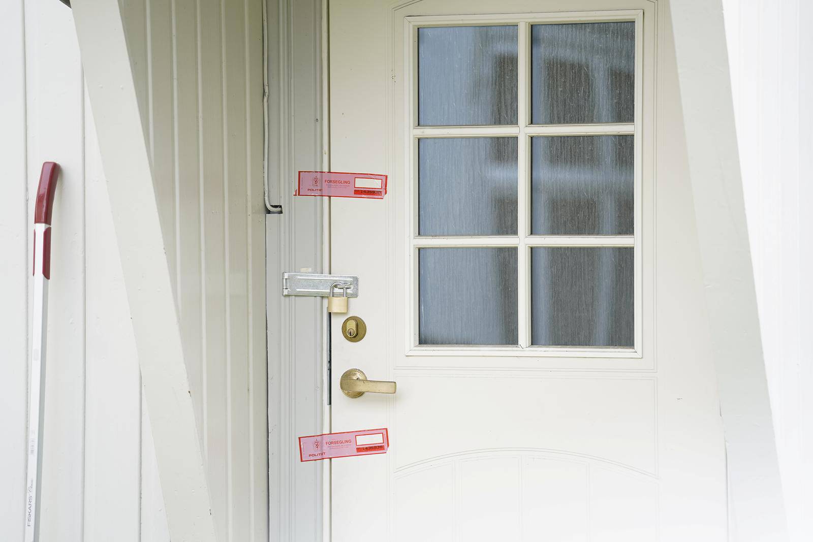 Police stickers are pictured on the door of a house of a suspect in a deadly attack in Kongsberg