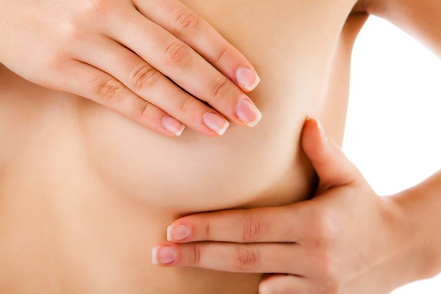 Woman examining her breast