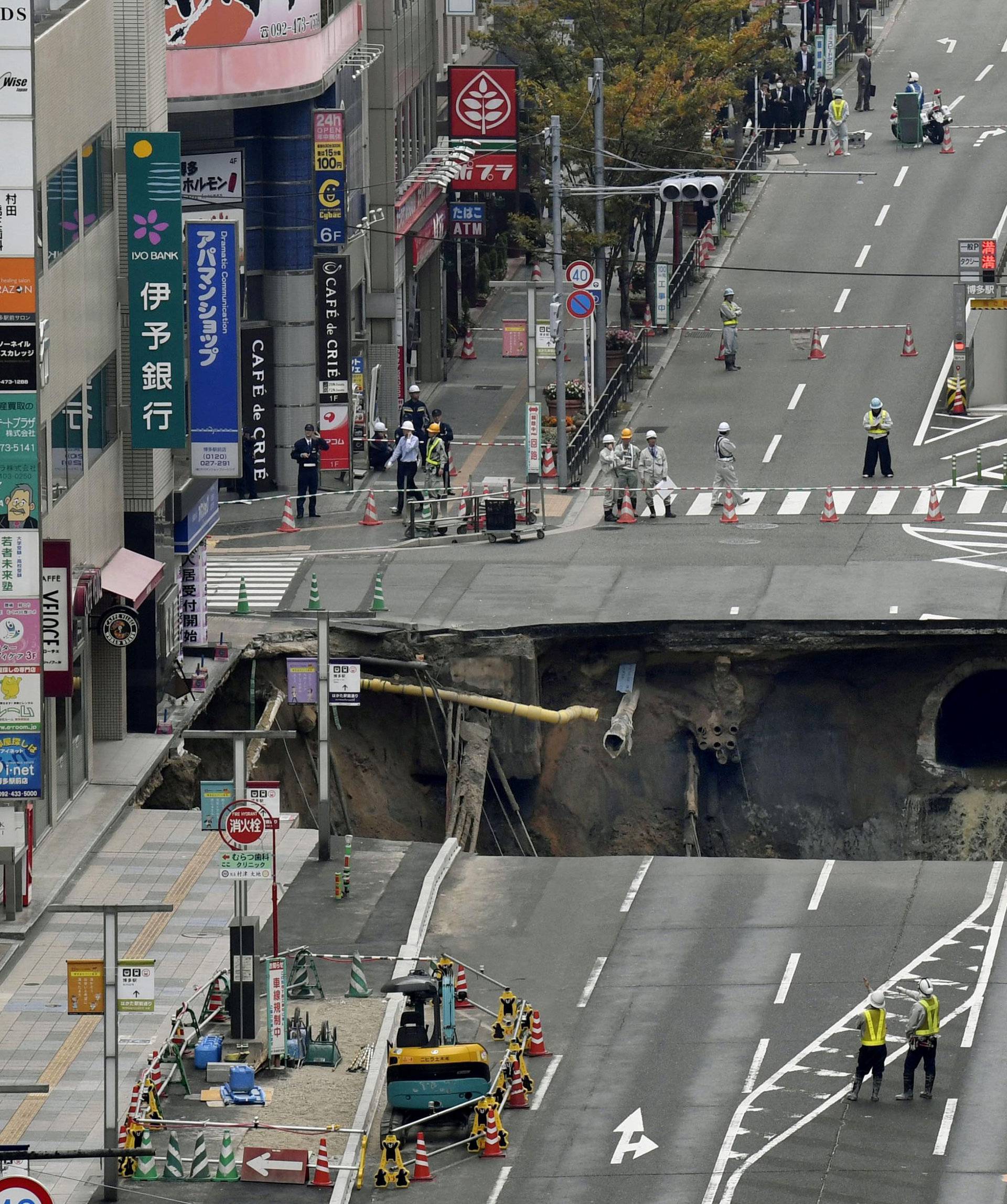 A huge sinkhole is seen at an intersection near Hakata station in Fukuoka, Japan