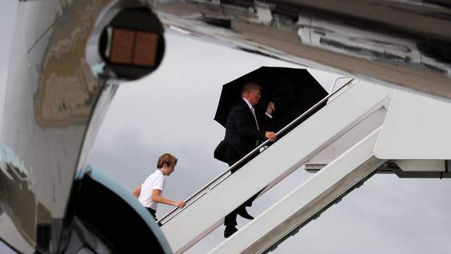 U.S. President Donald Trump and his son Barron board Air Force One as he departs West Palm Beach