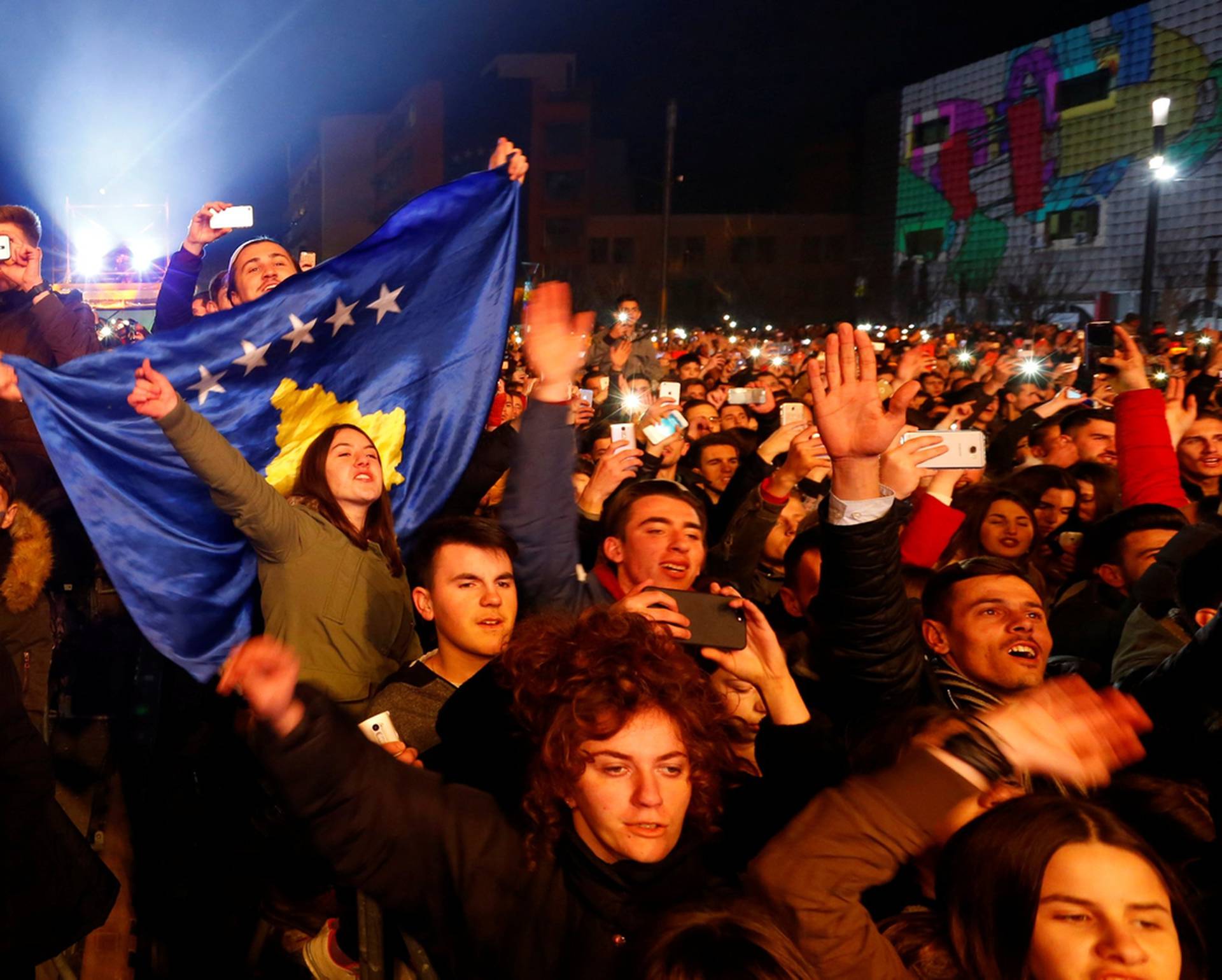 People cheer and take photos of Rita Ora's concert during celebration of the 10th anniversary of Kosovo's independence in Pristina