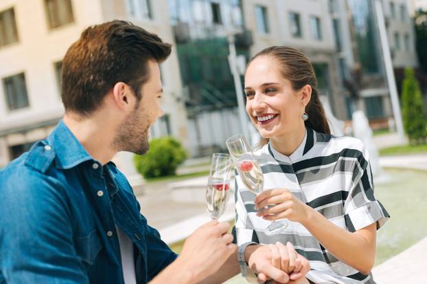 Delighted joyful people drinking champagne