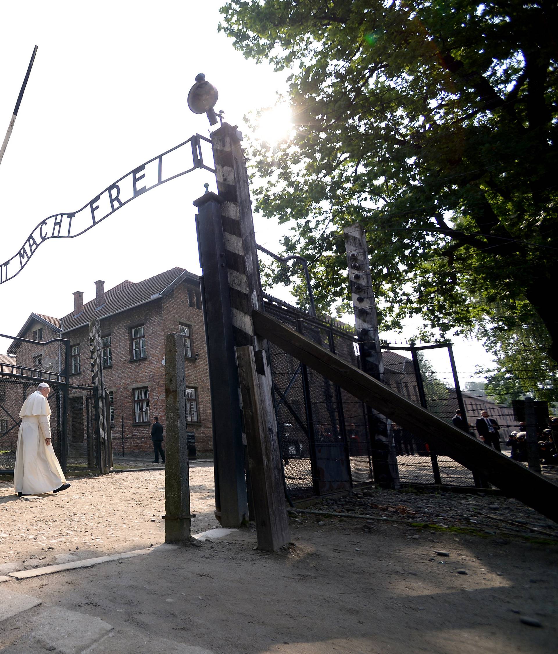 Pope Francis walks through Auschwitz's notorious gate during his visit to the former Nazi death camp