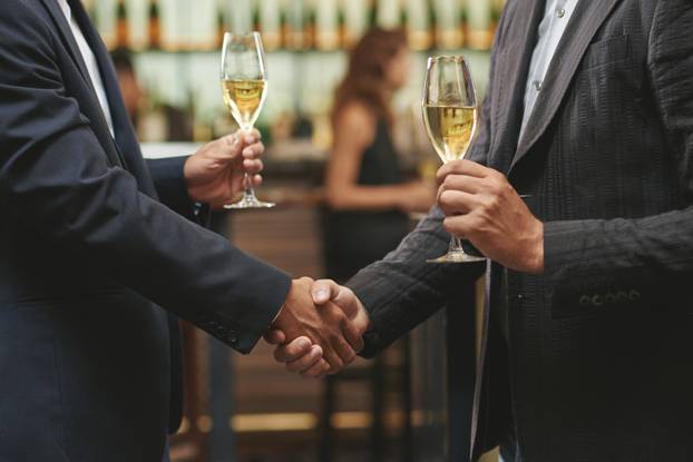 Hands,Of,Men,Shaking,Hands,And,Drinking,White,Wine