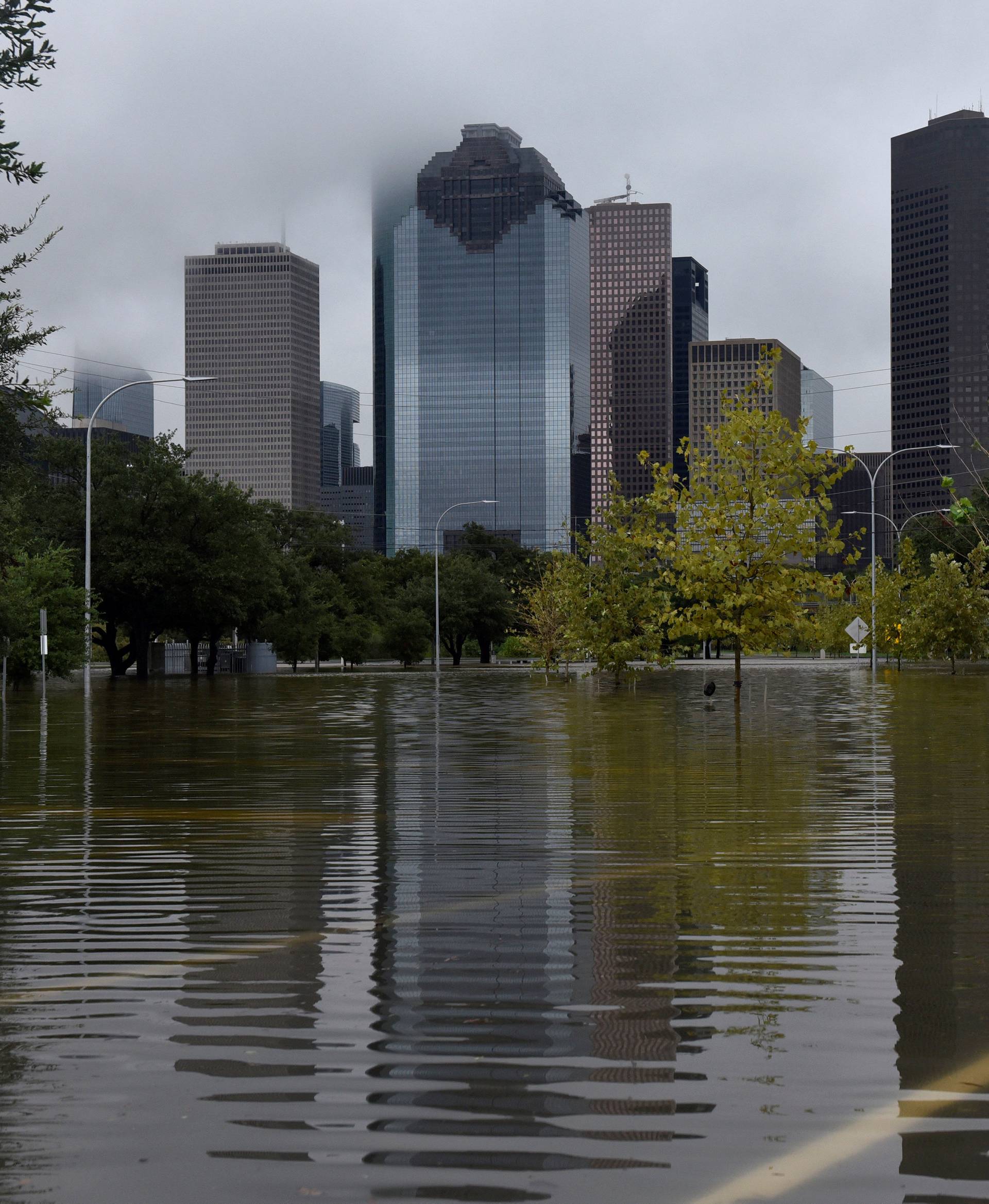 The downtown skyline is reflected in the flood water at Buffalo Bayou Park after Hurricane Harvey inundated the Texas Gulf coast with rain causing widespread flooding, in Houston, Texas