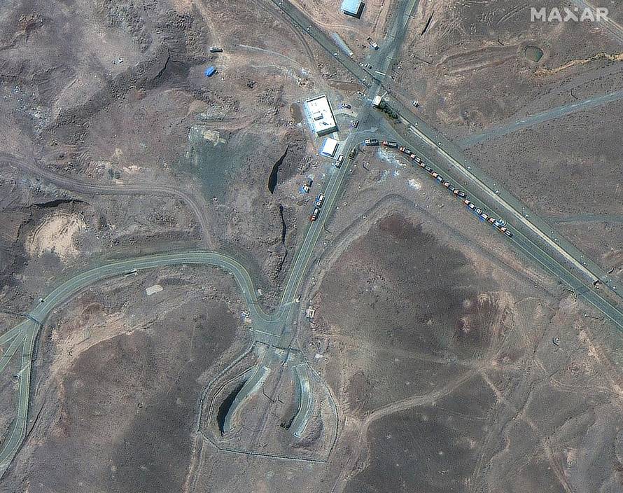 A satellite image shows trucks positioned near the entrance of the Fordow fuel enrichment facility, near Qom
