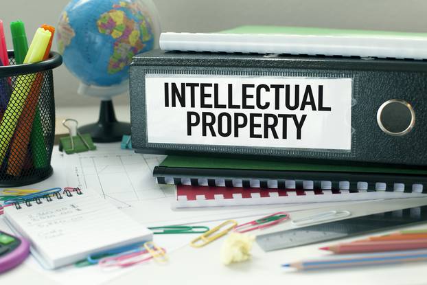 Intellectual,Property,Conceptual,Background,In,Office,With,Files,And,Papers