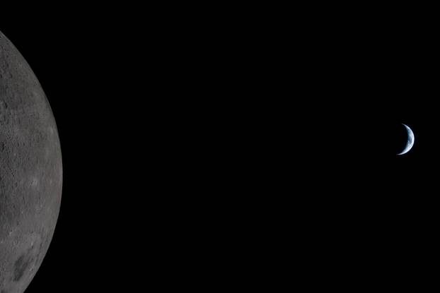 Earth passing the Moon as photographed through the Orion spacecraft window