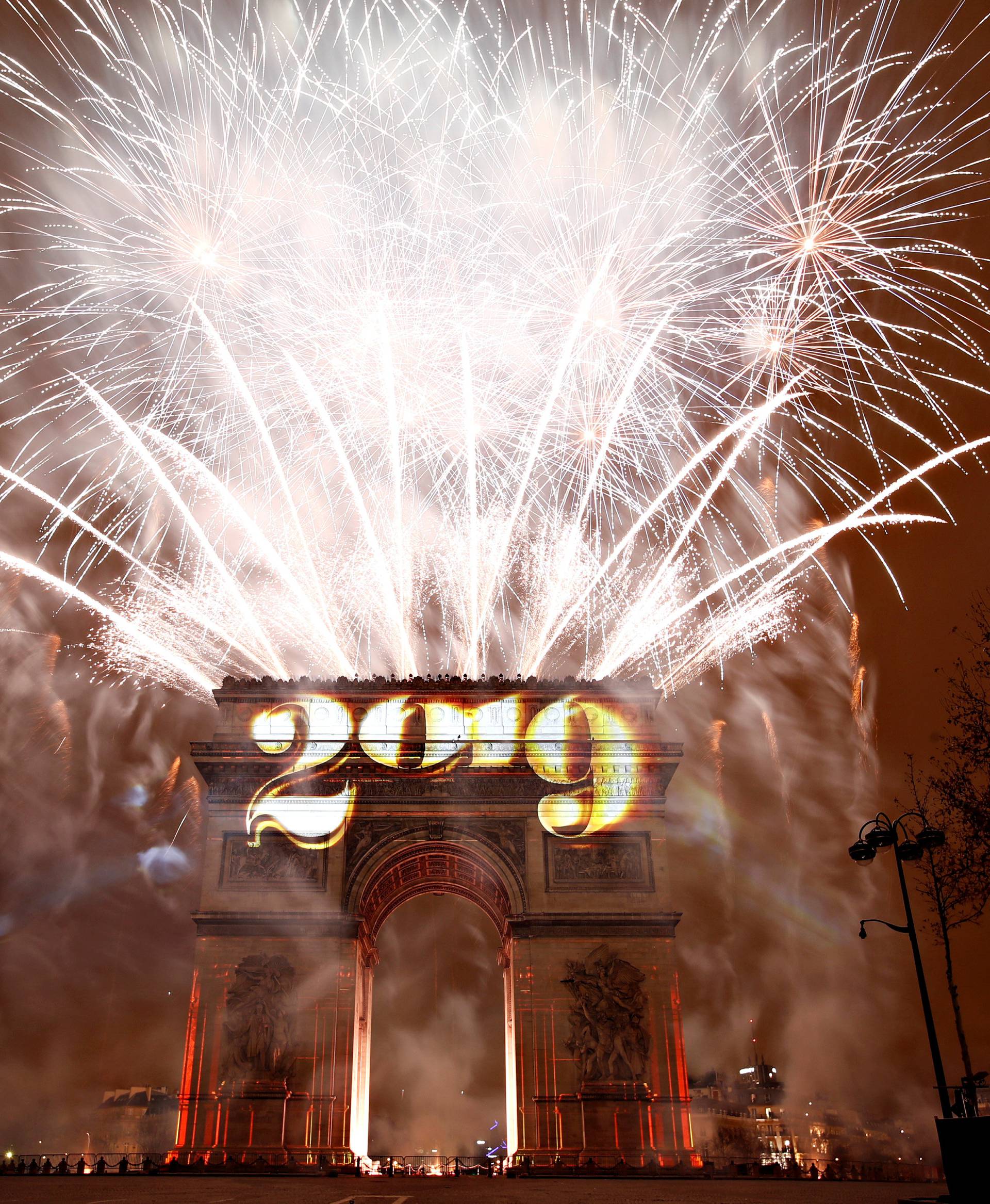 Fireworks explode during the New Year's celebrations at the Arc de Triomphe in Paris