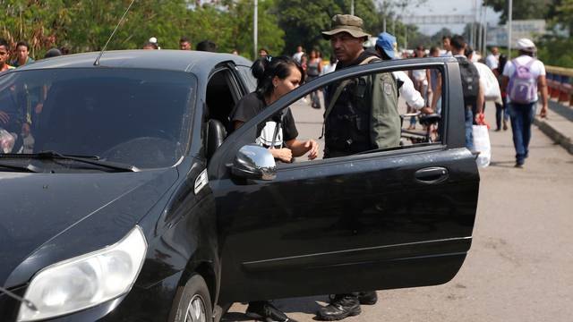 A woman gets out of her car at the request of a Venezuelan guard, on the Francisco de Paula Santander international bridge in Cucuta