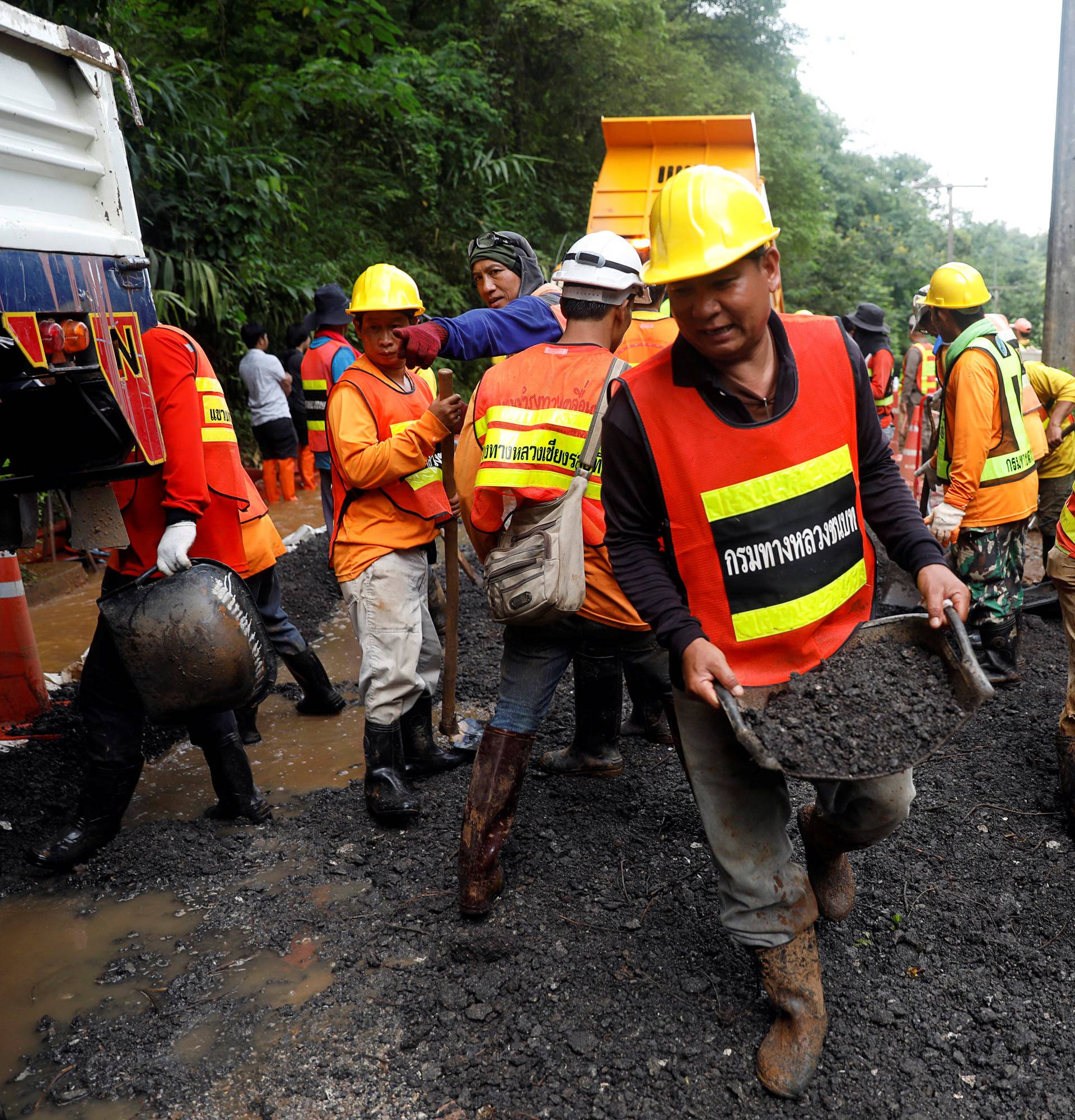 Rescue workers are seen near Tham Luang cave complex, as members of under-16 soccer team and their coach have been found alive according to a local media's report, in the northern province of Chiang Rai