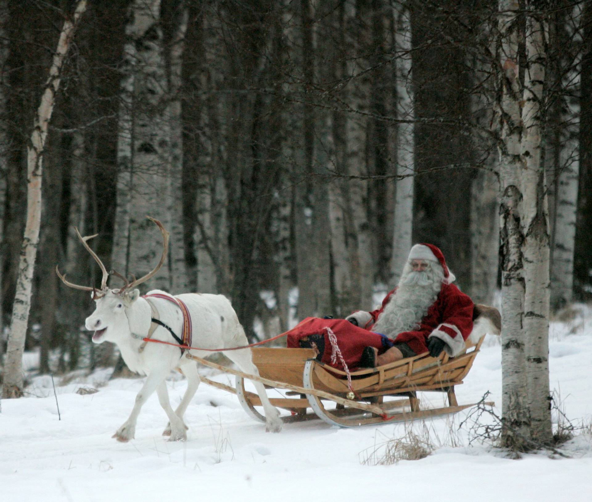 A man dressed as Santa Claus rides his sleigh as he prepares for Christmas on the Arctic Circle in Rovaniemi, northern Finland