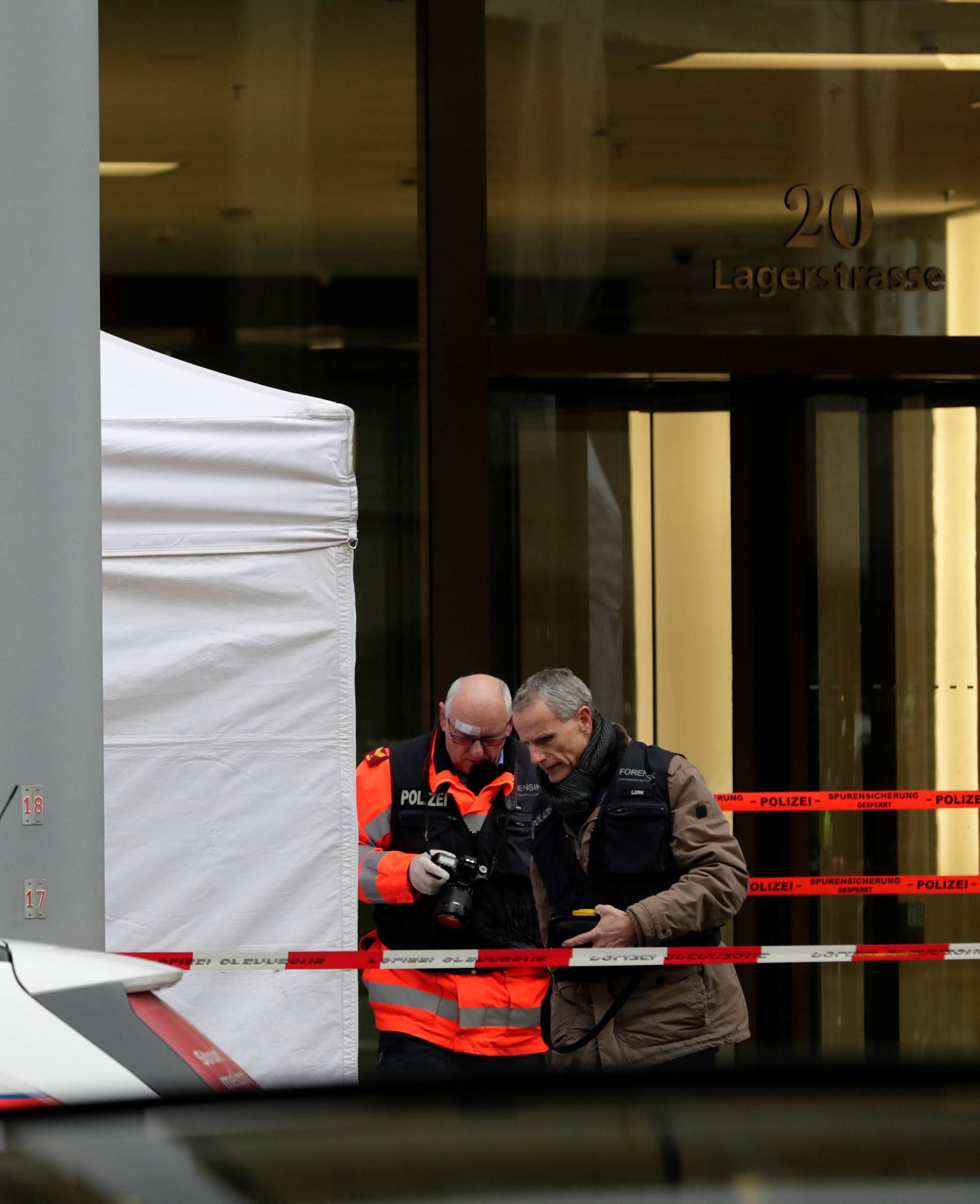 Police investigate a crime scene after two people, police said, were killed in Zurich