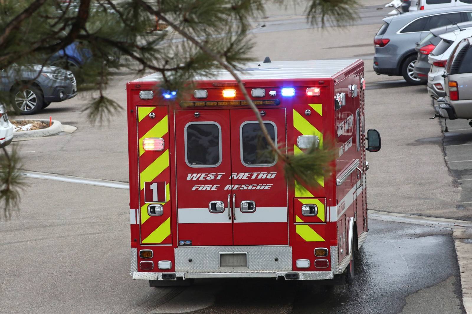An ambulance leaves the site of a shooting at a King Soopers grocery store in Boulder
