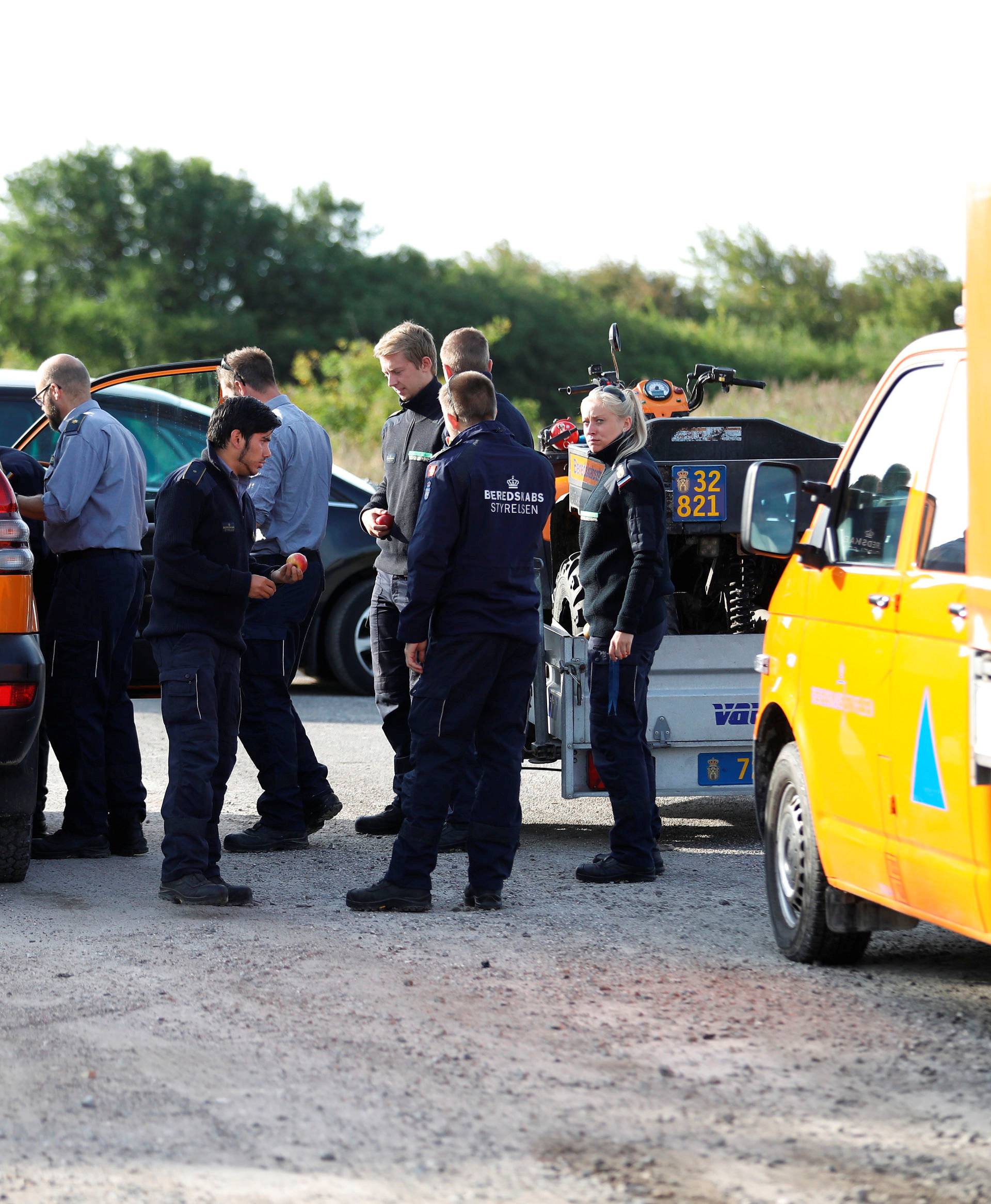 Members of The Danish Emergency Management Agency (DEMA) (Danish: Beredskabsstyrelsen) prepare to assist police at Kalvebod Faelled in Copenhagen