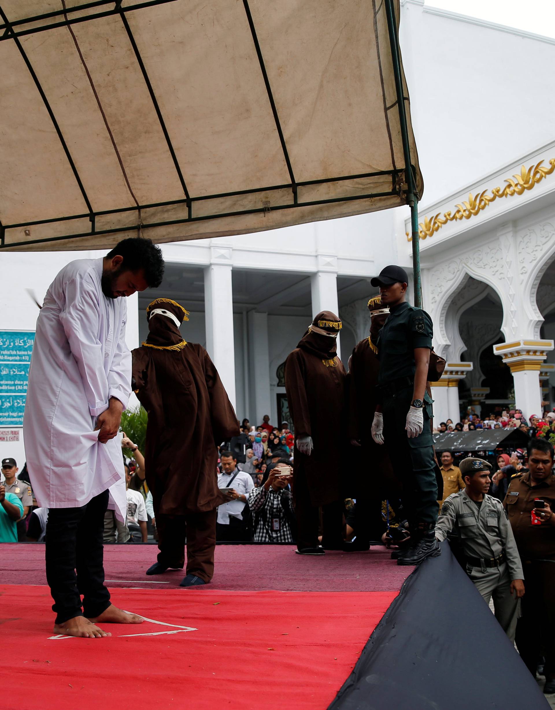 An Indonesian man is publicly caned for having gay sex, in Banda Aceh