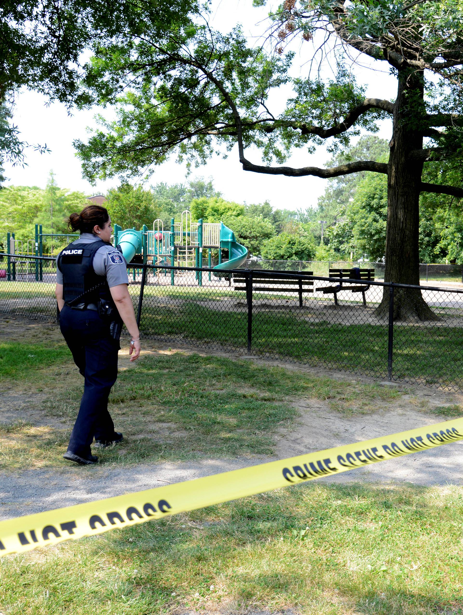 Police put up tape to clear journalists from the outfield area of a baseball field where shots were fired during a congressional baseball practice in Alexandria