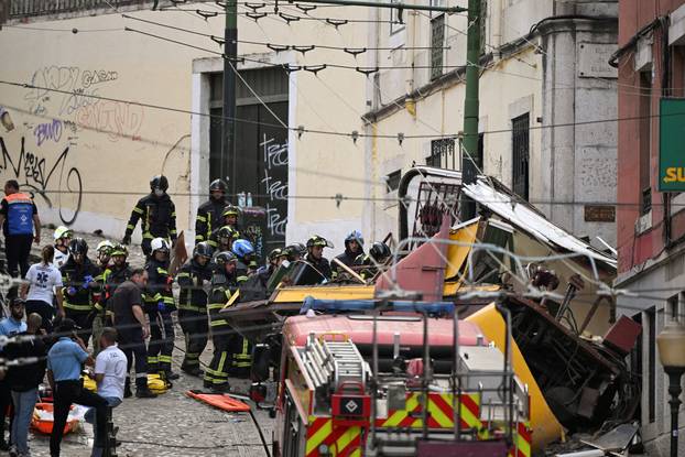 First responders work at the site of a funicular accident in Lisbon