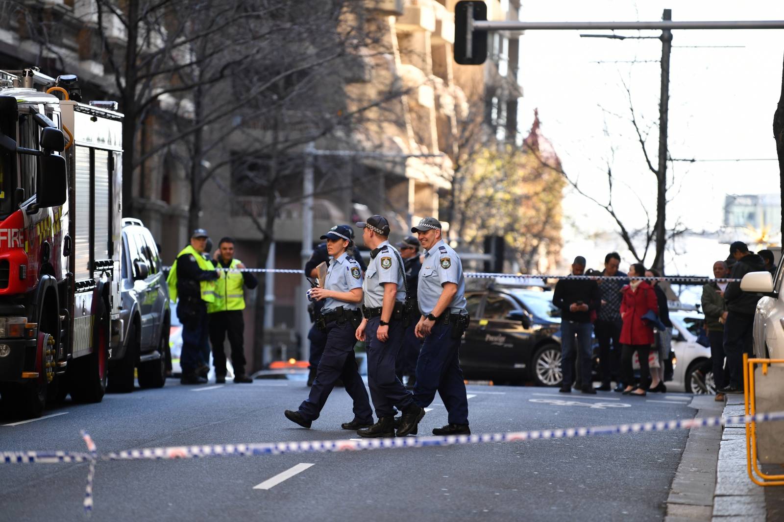 Police officers investigate a scene following reports of a stabbing in Sydney