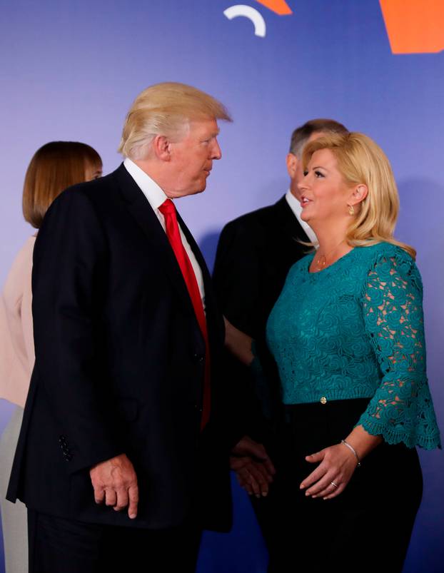 U.S. President Donald Trump talks to Croatian President Kolinda Grabar-Kitarovic during the Three Seas Initiative Summit in Warsaw